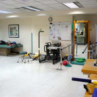A view of a physical therapy room equipped with various rehabilitation tools.