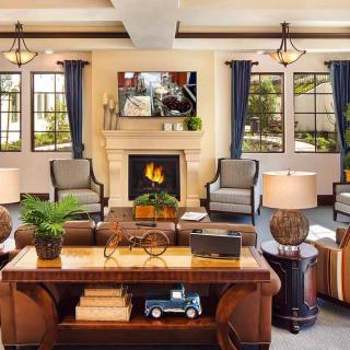 A cozy living room with elegant furnishings and a warm fireplace.