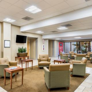 A modern lobby with comfortable seating and a television.