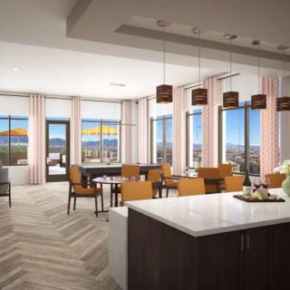 A modern open-concept kitchen and dining area with large windows and contemporary furnishings.