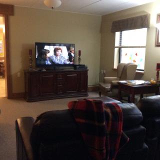A cozy living room with a television and comfortable seating arrangement.