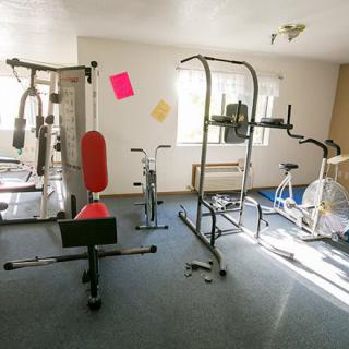 A small indoor gym with various exercise equipment.