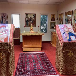 Interior view of an Orthodox church with icons and an altar.