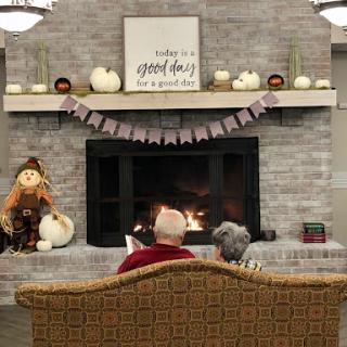 A cozy evening by the fireplace, surrounded by autumn decorations and warmth.