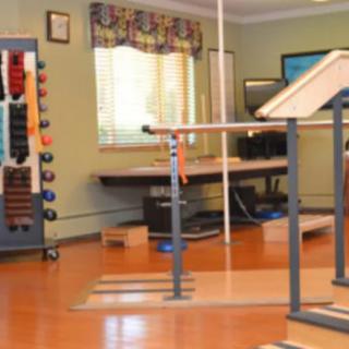 A well-equipped rehabilitation room with assorted exercise apparatus.