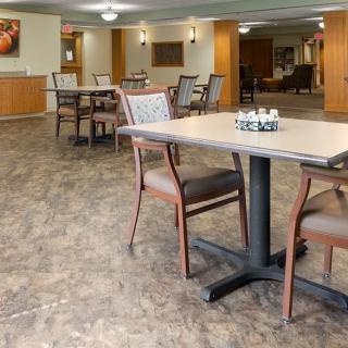 An indoor dining area with several tables and chairs arranged neatly, featuring a spacious and inviting atmosphere.
