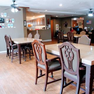 A spacious dining area with wooden tables and chairs set for guests.