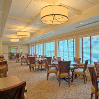 A spacious and elegantly designed lounge area with ample seating and natural light.