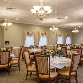 An elegant dining area set up with tables, chairs, and decorative elements.