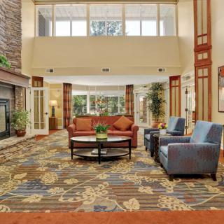 A spacious hotel lobby with comfortable seating and modern decor.