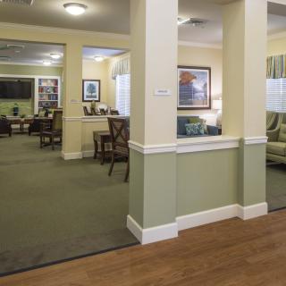 A cozy lounge area decorated with comfortable seating and wall art.