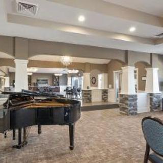A spacious lobby with a grand piano and comfortable seating.