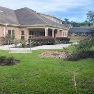 A house with a well-maintained garden and lawn.