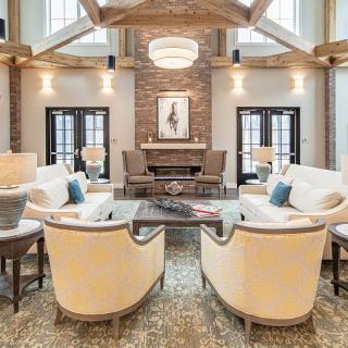A spacious and elegantly designed living room with modern furniture and a warm fireplace.