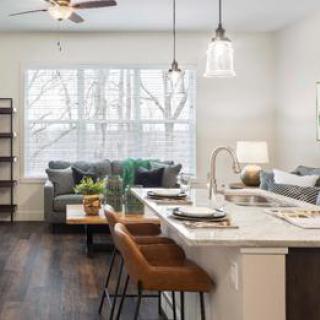 A beautifully designed open-concept living space featuring a modern kitchen and cozy seating area.