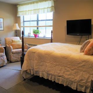 Cozy bedroom with a comfortable bed and seating area.