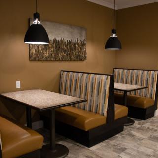 A cozy dining area with booth seating and modern decor in a restaurant.