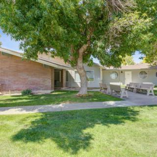 A suburban house with a well-maintained yard and large tree.