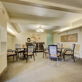A well-decorated meeting room with tables and chairs arranged for a group discussion.