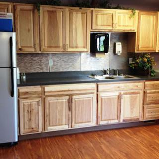 A warm and inviting kitchen featuring natural wooden cabinets and a simple layout.