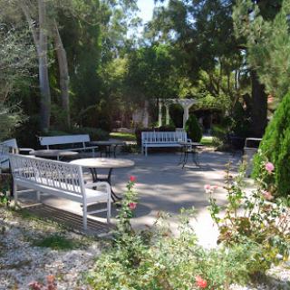 A serene garden space featuring benches and lush greenery, ideal for relaxation and enjoyment of nature.
