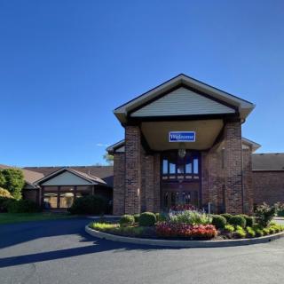 A church building with a prominent entrance under a clear blue sky.
