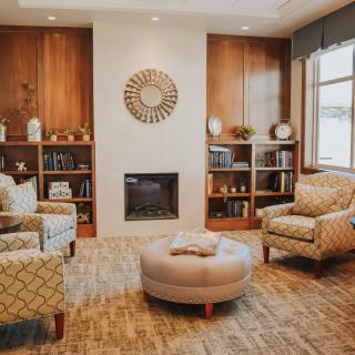 Cozy living room with comfortable seating and a central fireplace.