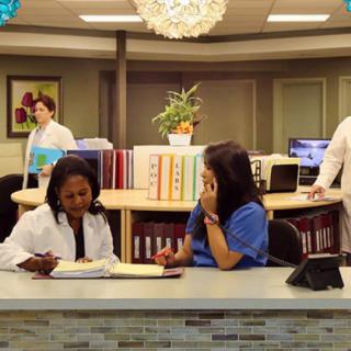 Medical staff working at a hospital reception area.