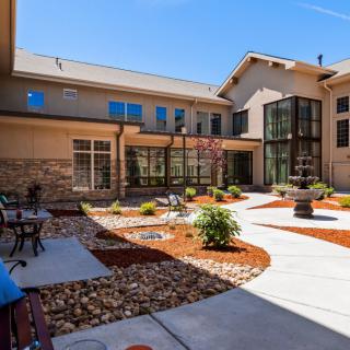 A modern courtyard with landscaped gardens and outdoor seating areas.