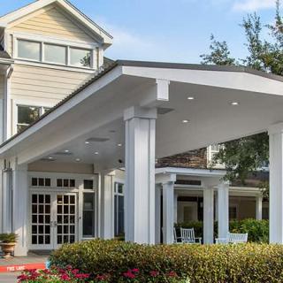 A beautiful residential house with a spacious porch and classic architectural features.