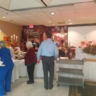A lively gathering with a buffet setup, showcasing a variety of dishes and an inviting atmosphere.