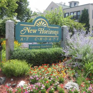 A landscaped garden with a sign reading 'New Horizons at Choate'.