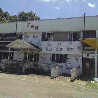 A view of a commercial building with signage visible on the fa�ade.