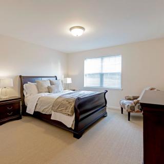 A cozy bedroom with elegant furniture and soft lighting.