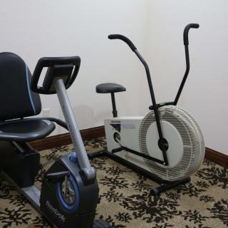 Two exercise bikes in a fitness room.