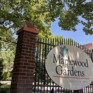 Entrance to Maplewood Gardens, showcasing a serene outdoor setting.