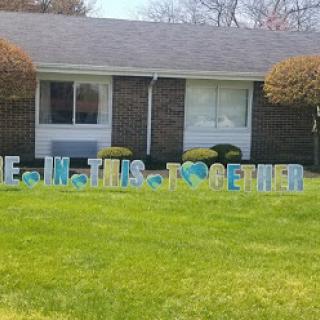 A heartfelt display of unity and support in a front yard.