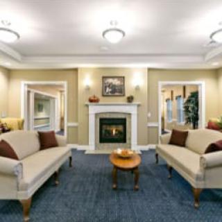 A cozy living room with two sofas facing each other and a fireplace in the center.