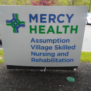 Sign for Mercy Health's Assumption Village, dedicated to skilled nursing and rehabilitation services.