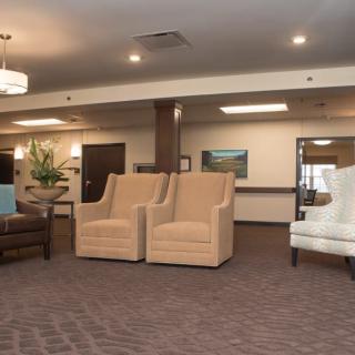 A spacious lobby area with comfortable seating and warm lighting.