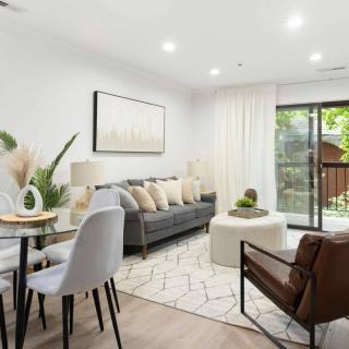 A modern living room with stylish decor and ample natural light.