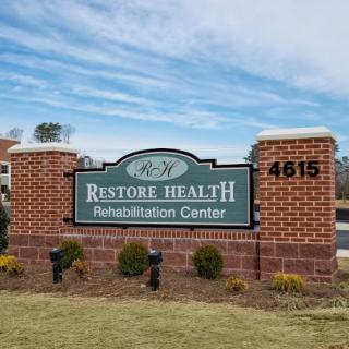 An outdoor sign for Restore Health Rehabilitation Center.