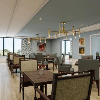 A well-lit dining room with elegant furnishings and a chandelier.