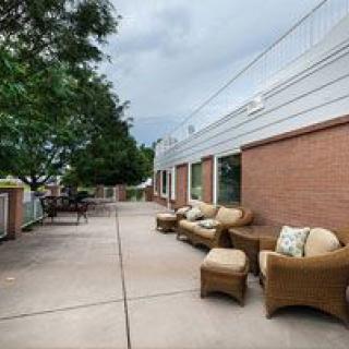 Spacious outdoor patio with comfortable seating and a view of trees.