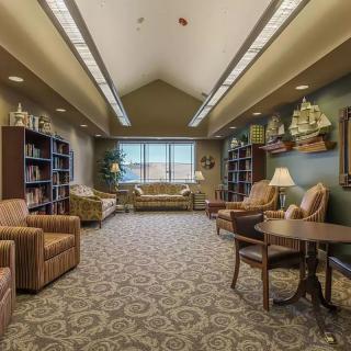 A cozy library sitting area with comfortable chairs and bookshelves.