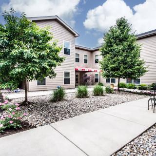 A landscaped courtyard outside a modern apartment building.