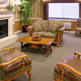 A cozy living room with classic furniture and a warm fireplace.