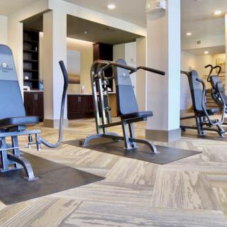 Modern gym with various exercise machines ready for use.