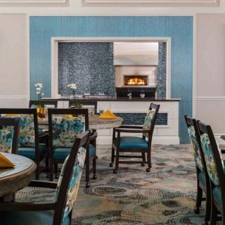 A stylish dining room with elegant blue decor and comfortable seating.