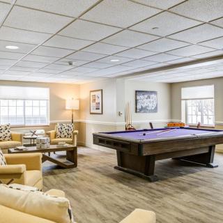 A well-appointed recreation room featuring a pool table and comfortable seating.